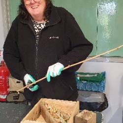 A woman working on a bug hotel