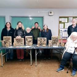 A group of people presenting the bug hotels they have made