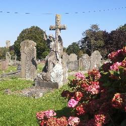 A headstone carved into a statue of an angel